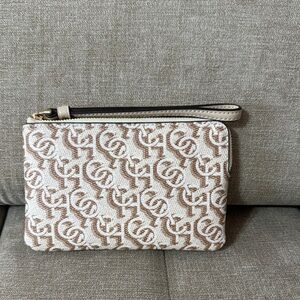 Coach cream leather wristlet with graphic coach logo
